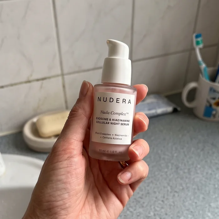 Lori holding Nudera bottle in bathroom